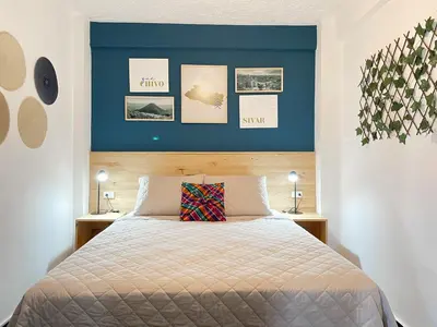 a bedroom with a bed with a blue wall at Casa Serena B&B in Nueva San Salvador