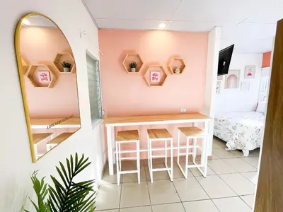 a room with a table and stools and a mirror at Casa Serena B&B in Nueva San Salvador