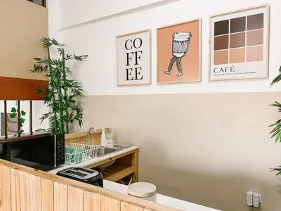 a coffee shop reception with a counter with a computer and plants at Casa Serena B&B in Nueva San Salvador