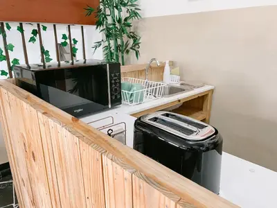 a kitchen with a microwave and a trash can at Casa Serena B&B in Nueva San Salvador