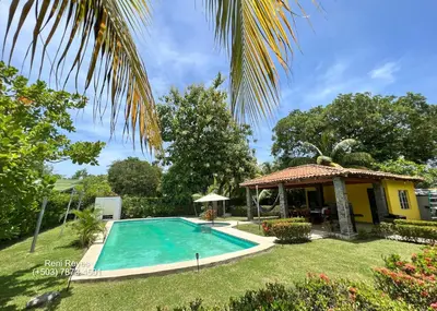 a swimming pool in a yard next to a house at Las Veraneras Villa - Pet Friendly in Acajutla