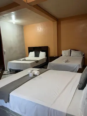 two beds in a hotel room with twoermottermott at Hotel y Restaurante La Perla, Cacaopera, Morazan, El Salvador in Cacaopera