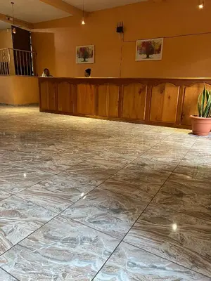 an empty room with a marble floor and a podium at Hotel y Restaurante La Perla, Cacaopera, Morazan, El Salvador in Cacaopera