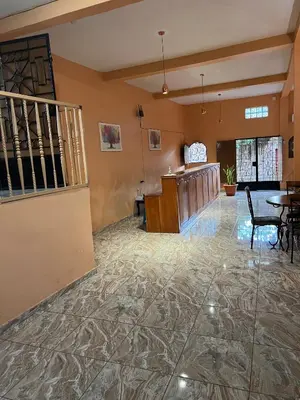 a lobby with a marble floor and a staircase at Hotel y Restaurante La Perla, Cacaopera, Morazan, El Salvador in Cacaopera