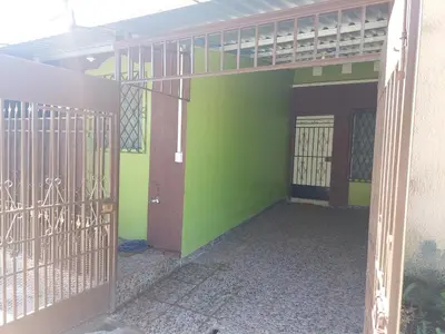 an entrance to a building with a green wall at Hostal La Campana in San Miguel