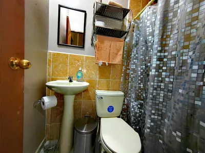 a bathroom with a toilet and a sink at Hostal La Campana in San Miguel