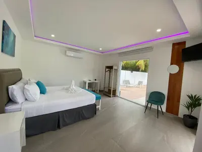 a bedroom with a bed and a sliding glass door at The Views Resort in El Zonte