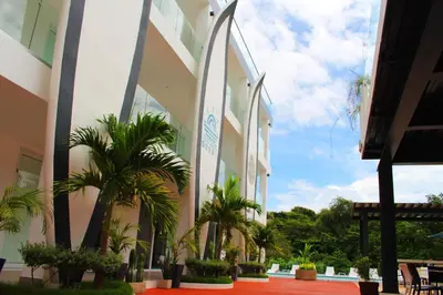 a building with palm trees in front of it at The Views Resort in El Zonte