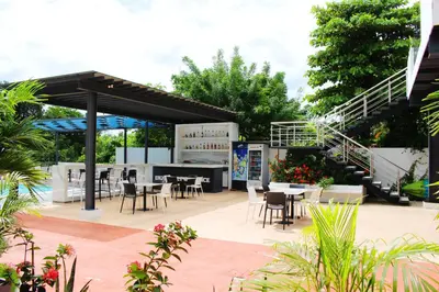 an outdoor patio with tables and chairs and stairs at The Views Resort in El Zonte