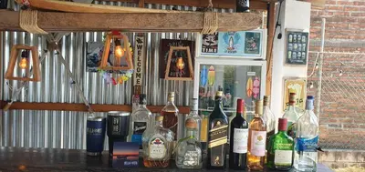 a bunch of bottles of wine on a bar at Bella Vista Hotel Boutique in San Miguel