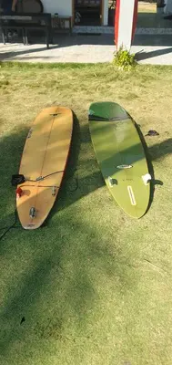 two surfboards sitting on the grass in the grass at Bella Vista Hotel Boutique in San Miguel