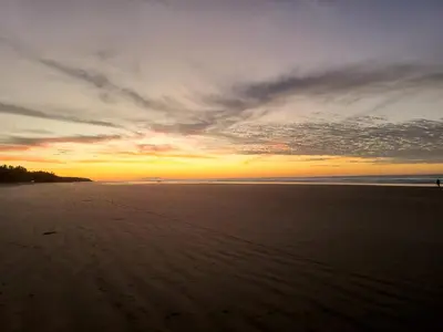 a sunset on a beach with the ocean at Bella Vista Hotel Boutique in San Miguel