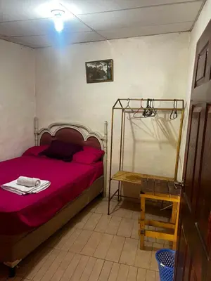 a bedroom with a red bed and a table at Casa isabel in Santa Ana