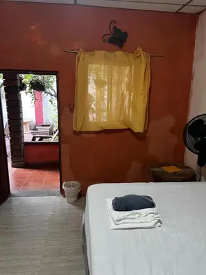 a bedroom with a bed with a yellow towel on it at Casa isabel in Santa Ana