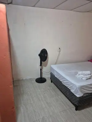 a bedroom with a bed and a fan in a room at Casa isabel in Santa Ana