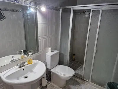 a bathroom with a toilet and a shower and a sink at Casa isabel in Santa Ana