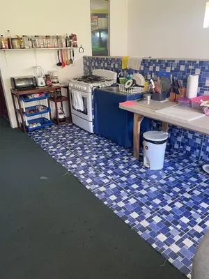 a kitchen with a blue and white tiled floor at Playa El Obispo E La Marea building La Libertad in La Libertad