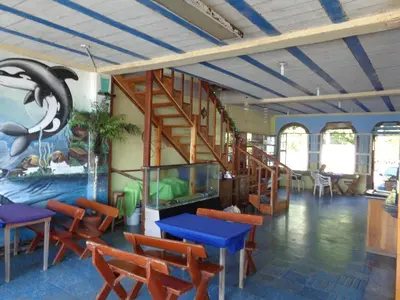 a room with tables and chairs and a staircase at Playa El Obispo E La Marea building La Libertad in La Libertad