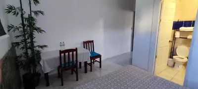a room with a table and two chairs and a toilet at Playa El Obispo E La Marea building La Libertad in La Libertad