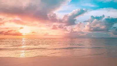 a sunset on a beach with the ocean at Playa El Obispo E La Marea building La Libertad in La Libertad