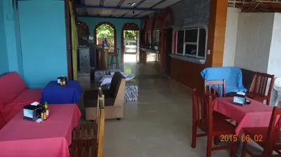 a restaurant with two tables and chairs with pink tables at Playa El Obispo E La Marea building La Libertad in La Libertad