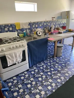 a kitchen with a stove and a blue and white tile floor at Playa El Obispo E La Marea building La Libertad in La Libertad
