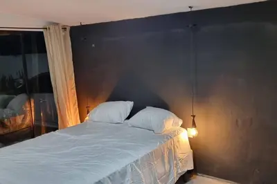 a bed with two pillows on it in a bedroom at Hermosa Casa de Playa DejaBlue SV in La Libertad