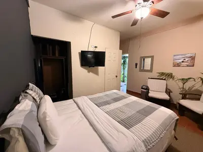 a bedroom with a bed and a ceiling fan at Los Portones de Ataco in Concepción de Ataco