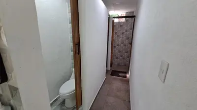 a bathroom with a toilet and a walk in shower at Hotel Zelen in Tamanique