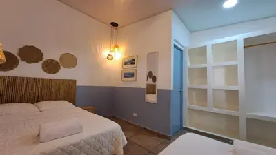 a bedroom with a bed and a window at Hotel Zelen in Tamanique