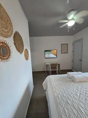 a bedroom with a bed and a ceiling fan at Hotel Zelen in Tamanique