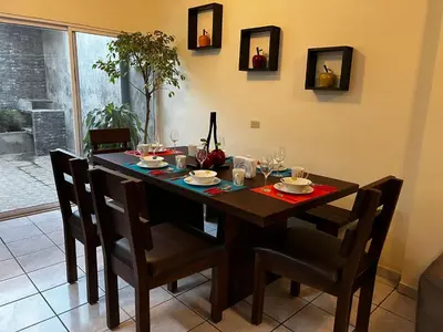 a dining room table with chairs and a table at Chalchuapa, Santa Ana La Casa de Sussy, El Salvador in Chalchuapa