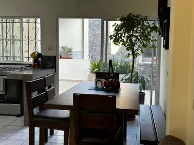 a kitchen with a table and chairs and a kitchen with a view at Chalchuapa, Santa Ana La Casa de Sussy, El Salvador in Chalchuapa