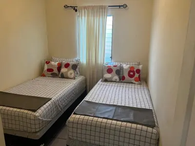 two twin beds in a room with a window at Chalchuapa, Santa Ana La Casa de Sussy, El Salvador in Chalchuapa