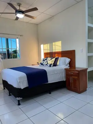 a bedroom with a bed and a ceiling fan at Chalchuapa, Santa Ana La Casa de Sussy, El Salvador in Chalchuapa
