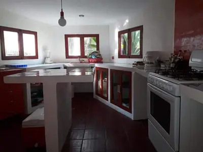a kitchen with a white counter top and a stove at MARDEORO BEACH HOUSE in Barra de Santiago
