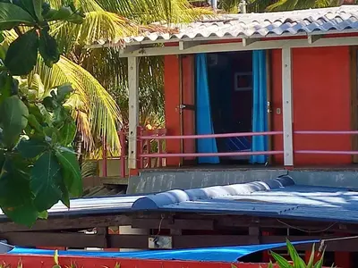 a house with a swimming pool in front of it at MARDEORO BEACH HOUSE in Barra de Santiago