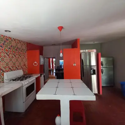 a kitchen with a stove and a refrigerator at MARDEORO BEACH HOUSE in Barra de Santiago