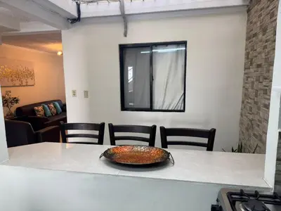 a bowl on a table in a room with chairs at Merliot, Sta Tecla Frente Cto Comer La Plaza Merliot in Nueva San Salvador