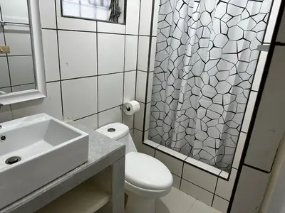 a bathroom with a toilet and a sink and a shower at Merliot, Sta Tecla Frente Cto Comer La Plaza Merliot in Nueva San Salvador