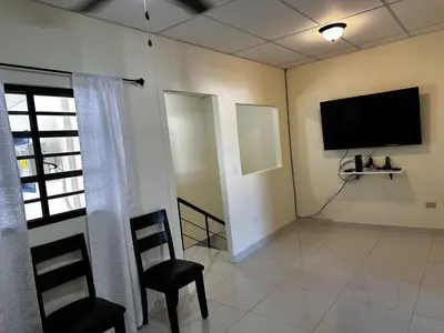 a living room with a flat screen tv on the wall at Merliot, Sta Tecla Frente Cto Comer La Plaza Merliot in Nueva San Salvador