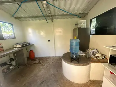 a kitchen with a large blue water bottle on a counter at Surf City Town House in La Libertad
