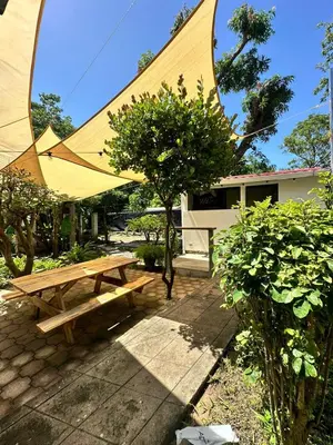 a picnic table with a large tent in front of a building at Surf City Town House in La Libertad