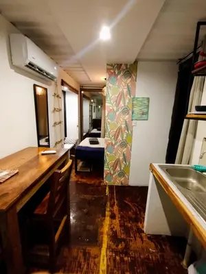 a room with a sink and a bedroom with a bed at CASA V - Mizata in Santa María Mizata