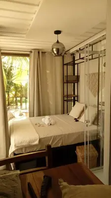 a bedroom with a bed and a glass window at CASA V - Mizata in Santa María Mizata