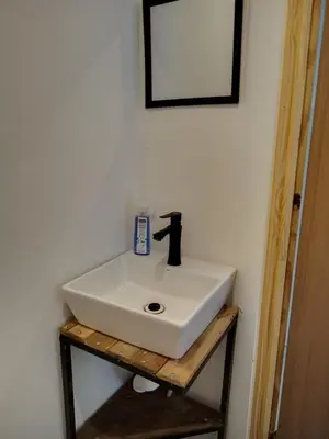 a white sink on a wooden stand in a bathroom at CASA V - Mizata in Santa María Mizata