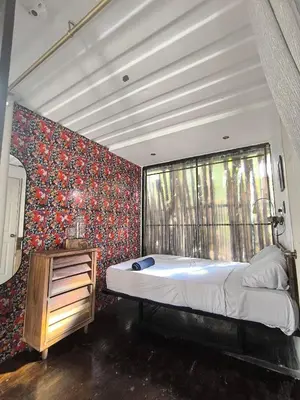 a bedroom with a large bed and a window at CASA V - Mizata in Santa María Mizata