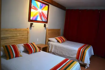 a hotel room with two beds and a stained glass window at Hotel Los Mangos El Salvador in El Cuco