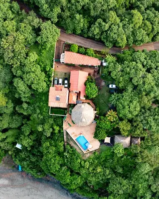 an aerial view of a house in the forest at Hotel Los Mangos El Salvador in El Cuco