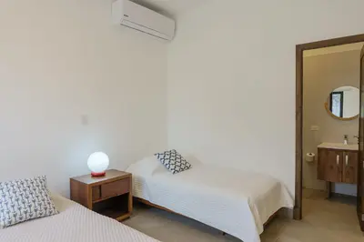 a bedroom with two beds and a mirror at Ayanna Beach Front in La Libertad